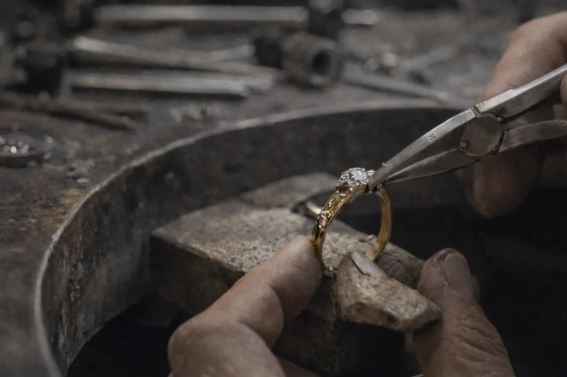 Jeweller repairing a diamond ring on a workbench